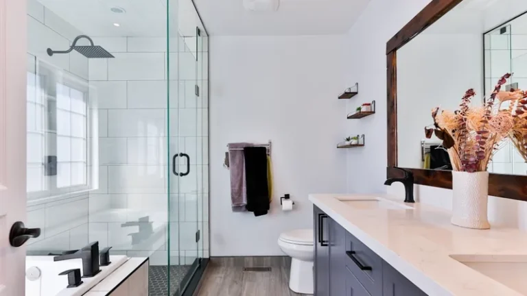 Modern renovated bathroom with glass shower and double vanity, representing bathroom renovation costs in Sydney
