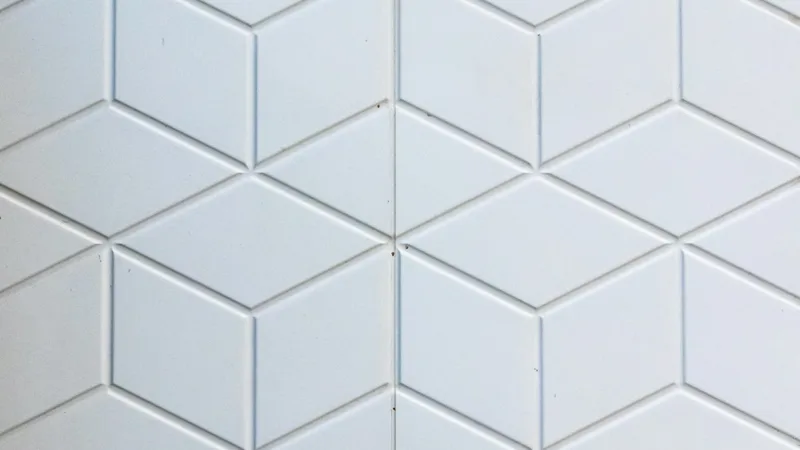 Close-up of geometric bathroom wall tiles, representing bathroom waterproofing and tiling